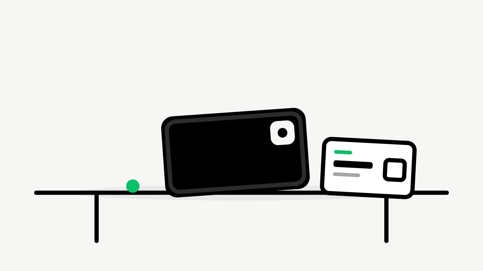 A phone lying face-down on a café table, a Taxista card beside it.